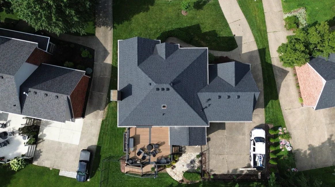 Top down aerial view of a home with a new gray shingle roof