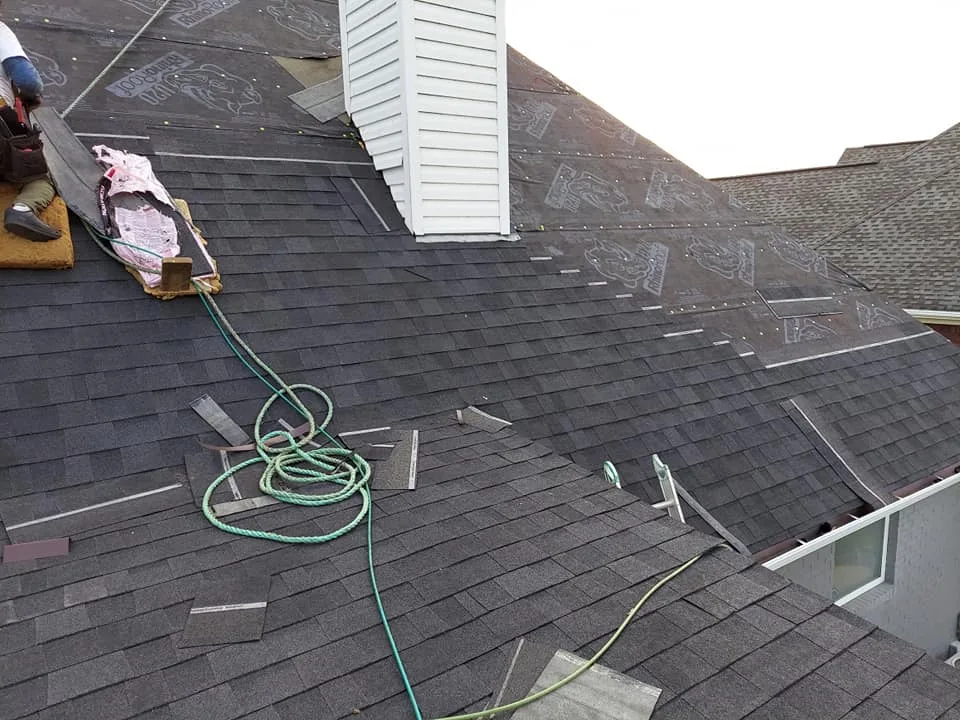 New shingles being installed around a chimney