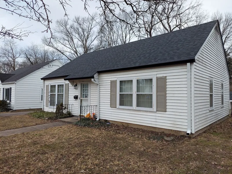 White siding house with a clean, freshly finished exterior